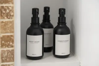 three bottles of wine sitting on a shelf at Stylish Apartment - Light Rail Access in Bayonne