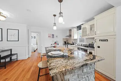 a kitchen with a marble counter top in a room at Stylish Apartment - Light Rail Access in Bayonne