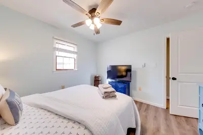 a bedroom with a bed and a ceiling fan at Arrowhead Lake Access and Fire Pit Serene Cottage in Pocono Lake