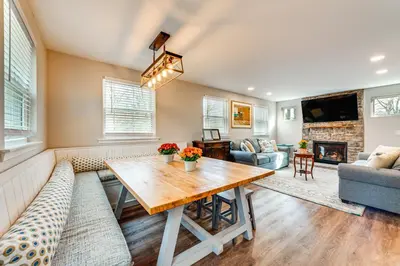 a living room with a table and a couch at Arrowhead Lake Access and Fire Pit Serene Cottage in Pocono Lake