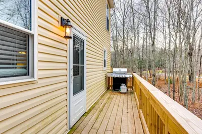 a porch of a house with a grill on it at Arrowhead Lake Access and Fire Pit Serene Cottage in Pocono Lake
