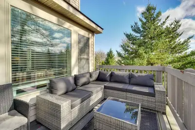 a patio with a couch on a balcony at 1 Mi to Waterpark Mtn-View Poconos Hideaway! in Tannersville