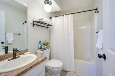 a bathroom with a sink and a toilet and a shower at 1 Mi to Waterpark Mtn-View Poconos Hideaway! in Tannersville