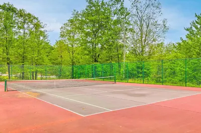 a tennis court with a net on it at 1 Mi to Waterpark Mtn-View Poconos Hideaway! in Tannersville