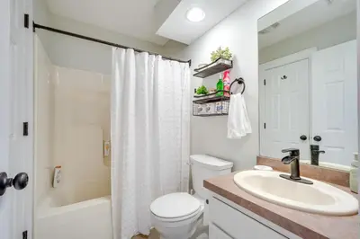 a white bathroom with a sink and a toilet at 1 Mi to Waterpark Mtn-View Poconos Hideaway! in Tannersville