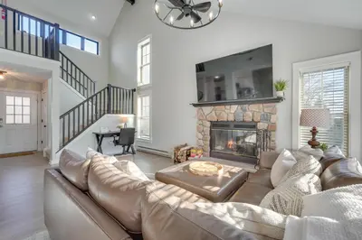 a living room with a couch and a fireplace at 1 Mi to Waterpark Mtn-View Poconos Hideaway! in Tannersville