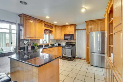 a kitchen with wooden cabinets and a counter top at Monroe Home Near LEGOland and State Parks! in Monroe