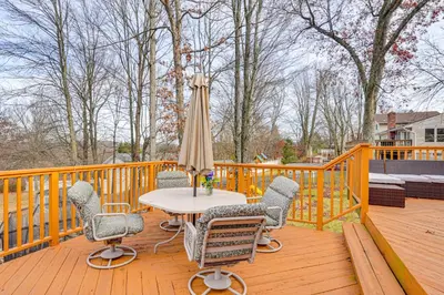 a wooden deck with a table and chairs and an umbrella at Monroe Home Near LEGOland and State Parks! in Monroe