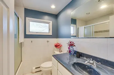 a bathroom with a sink and a toilet and a mirror at Monroe Home Near LEGOland and State Parks! in Monroe