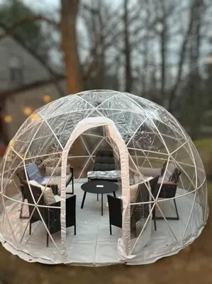 a dome tent with a table and chairs in it at Cozy Poconos Retreat Hot tub, Game room and igloo in Tobyhanna