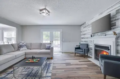 a living room with a couch and a fireplace at Cozy Poconos Retreat Hot tub, Game room and igloo in Tobyhanna