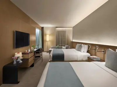 a hotel room with two beds and a flat screen tv at The Knickerbocker in New York