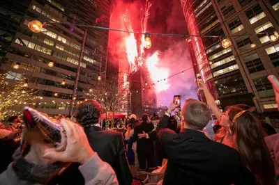 a crowd of people watching a fireworks show at The Knickerbocker in New York