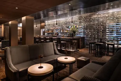 a bar with couches and a bar with a counter at The Knickerbocker in New York