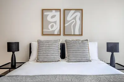 a bedroom with two pictures on the wall above a bed at Blueground UWS gym elevator nr Central Park NYC-1443 in New York