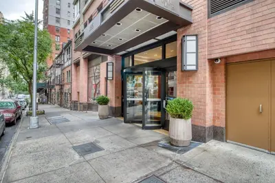 a sidewalk in front of a brick building at Blueground UWS gym elevator nr Central Park NYC-1443 in New York