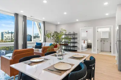a dining room and living room with a table and chairs at Stunning 1-BD - City Views - Near Fishtown in Philadelphia