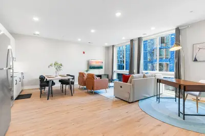 a living room with a table and a dining room at Stunning 1-BD - City Views - Near Fishtown in Philadelphia