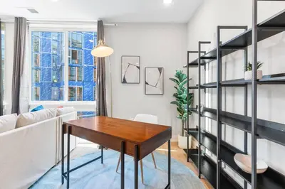 a living room with a table and a couch at Stunning 1-BD - City Views - Near Fishtown in Philadelphia
