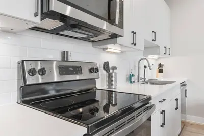 a kitchen with a stove and a sink at Stunning 1-BD - City Views - Near Fishtown in Philadelphia