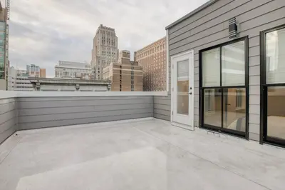 an empty balcony with a view of the city at One Sky Loft in Philadelphia