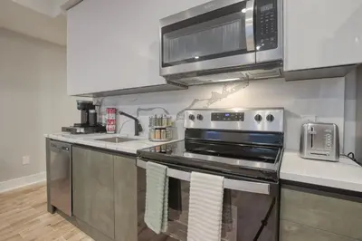 a kitchen with a stove and a microwave at One Sky Loft in Philadelphia