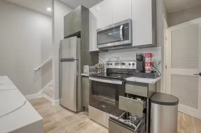 a kitchen with a refrigerator and a stove top oven at One Sky Loft in Philadelphia