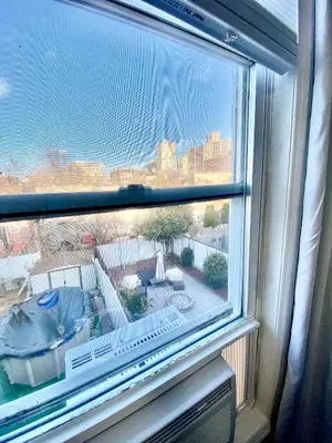 a window with a view of a city at Private Room C West NY, NJ 12 mints from NYCity Times Square in West New York