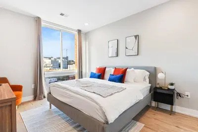 a bedroom with a large bed and a large window at Near Fishtown and Old City - King Bed - City Views in Philadelphia
