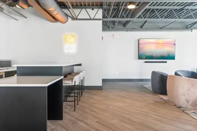 a room with a counter and chairs and a painting on the wall at Near Fishtown and Old City - King Bed - City Views in Philadelphia