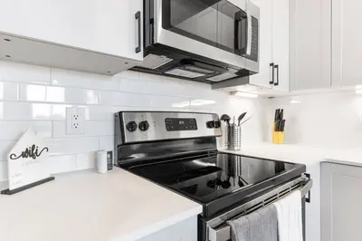 a kitchen with a stove and a microwave at Near Fishtown and Old City - King Bed - City Views in Philadelphia