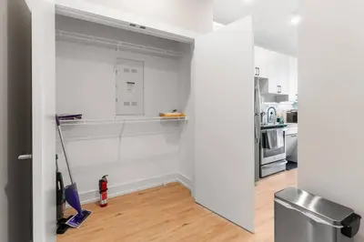 a white kitchen with a mop in a room at Waterfront Studio - Near Fishtown and Old City in Philadelphia