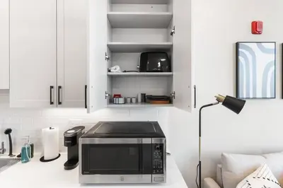 a microwave sitting on a counter in a kitchen at Waterfront Studio - Near Fishtown and Old City in Philadelphia
