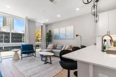 a kitchen and living room with a couch and a table at Sleeps 6 - Pier Views - Near Fishtown and Old City in Philadelphia