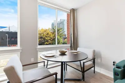 a dining room with a table and chairs and a window at 1BD Sleeps 4 with Views - Near Fish Town and Old City in Philadelphia