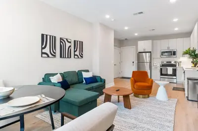 a living room with a couch and a table at 1BD Sleeps 4 with Views - Near Fish Town and Old City in Philadelphia