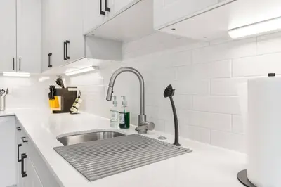 a kitchen with a sink and a faucet at 1BD Sleeps 4 with Views - Near Fish Town and Old City in Philadelphia
