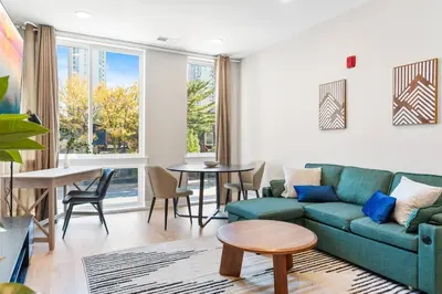 a living room with a couch and a table at Modern 1-BD - Pier Views - Near Old City in Philadelphia