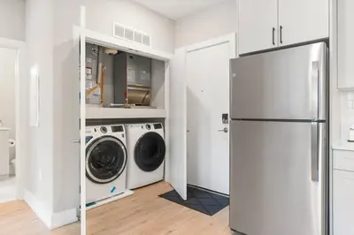 a kitchen with a washer and dryer and a refrigerator at Modern 1-BD - Pier Views - Near Old City in Philadelphia