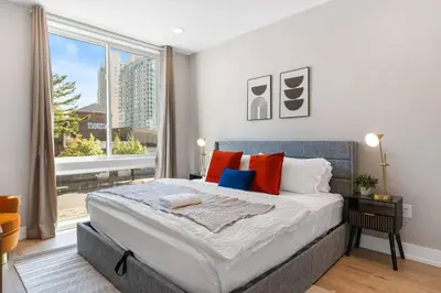 a bedroom with a large bed and a large window at 1BD - Sleeps 4 - Harbor Views - Near Fish Town- in Philadelphia