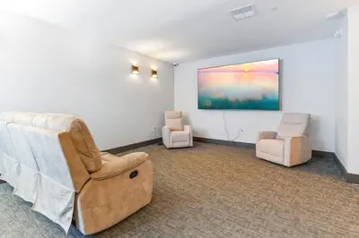 a living room with two chairs and a painting on the wall at 1BD - Sleeps 4 - Harbor Views - Near Fish Town- in Philadelphia