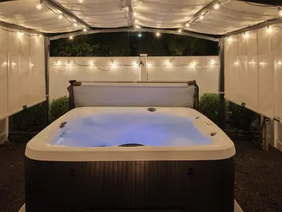 a jacuzzi tub in a tent with lights at The Lambertville Haven in Lambertville