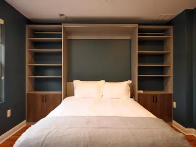 a bedroom with a large bed with wooden shelves at The Lambertville Haven in Lambertville