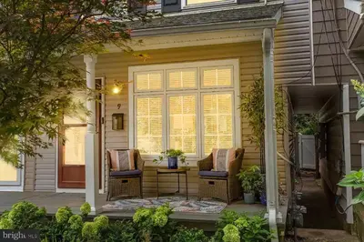 a front porch with two chairs and a table at The Lambertville Haven in Lambertville