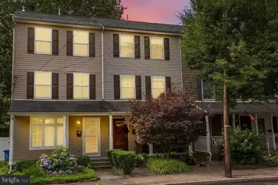 a gray house with windows on a street at The Lambertville Haven in Lambertville