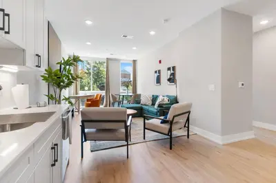 a kitchen and living room with a couch and chairs at King Bed - Stunning Pier Views - Near Fishtown in Philadelphia