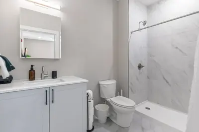 a white bathroom with a toilet and a shower at Amazing City Views - Sleeps 6 - Near Fishtown in Philadelphia