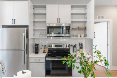 a white kitchen with a stove and a refrigerator at Amazing City Views - Sleeps 6 - Near Fishtown in Philadelphia