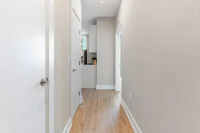 a hallway with white walls and a wooden floor at Amazing City Views - Sleeps 6 - Near Fishtown in Philadelphia