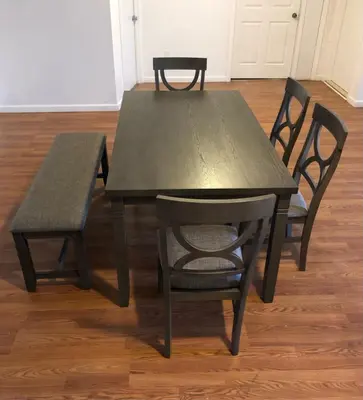 a wooden table with two chairs and a wooden floor at Large apartment, sleeps up to 10 people comfortably, direct NYC Manhattan train only 5 minute walk away, MetLife Stadium FIFA World Cup 25 minutes away in Elizabeth
